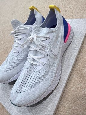 Nike Women's White Flyknit Trainers with Blue, Pink & Yellow Accents